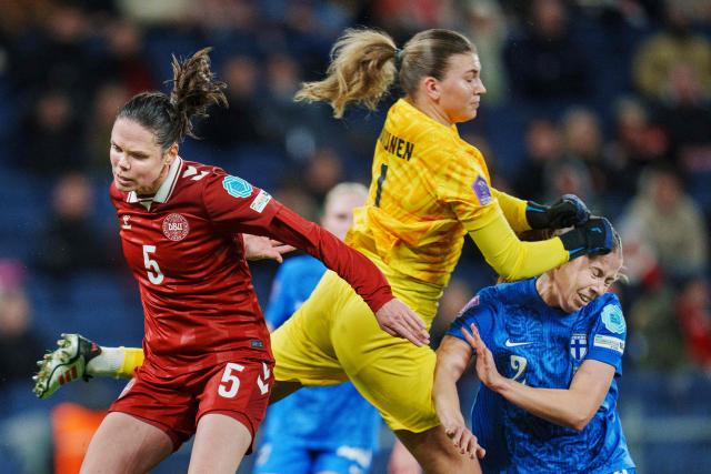 Denmark's Simone Boye Soerensen (L-R) Finland's goalkeeper Anna Koivunen and Maaria Roth vie for the ball during the UEFA Women's Nations League play-off, 2nd-leg football match between Denmark and Finland in Copenhagen, Denmark on October 28, 2025. (Photo by Liselotte Sabroe / Ritzau Scanpix / AFP) / Denmark OUT