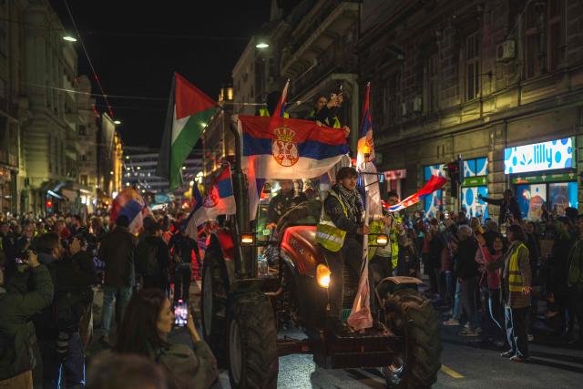 Students arrive in Belgrade flying Serbian and a Palestinian flag late on October 28, 2025, after almost two weeks of marching from the southwestern city of Novi Pazar on their way to Novi Sad, where they plan to arrive on November 1. Nearly one year ago, on November 1, 2024, a railway station canopy collapsed in Serbia's second city of Novi Sad, killing 16 people and triggering huge demonstrations. (Photo by Andrej ISAKOVIC / AFP)