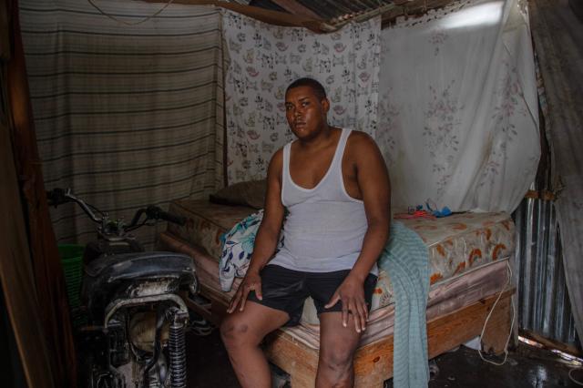 Dominican Mario Cuevas sits on a bed inside a house ahead of the arrival of Hurricane Melissa in Barahona, Dominican Republic on October 28, 2025. (Photo by Carlos FABAL / AFP)