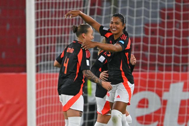 Colombia's defender #04 Ana Guzman and defender #03 Daniela Arias celebrates at the end of the Conmebol Women's Nations League 2025-26 football match between Ecuador and Colombia at the Rodrigo Paz Delgado Stadium in Quito on October 28, 2025. (Photo by Rodrigo BUENDIA / AFP)