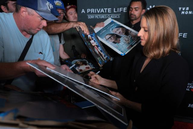 US actress Jodie Foster signs autographs to her fans during the premiere of her movie "A Private Life" on the opening night of The American French Film Festival (TAFFF) at the DGA Theater in Los Angeles, California on October 28, 2025. (Photo by Etienne LAURENT / AFP)