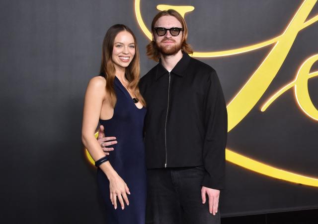 US record producer and songwriter Finneas (R) and partner US content creator, actress and entrepreneur Claudia Sulewski attend the premiere of HBO's "I Love LA" at the Paramount Theatre in Los Angeles, California on October 28, 2025. (Photo by Chris DELMAS / AFP)