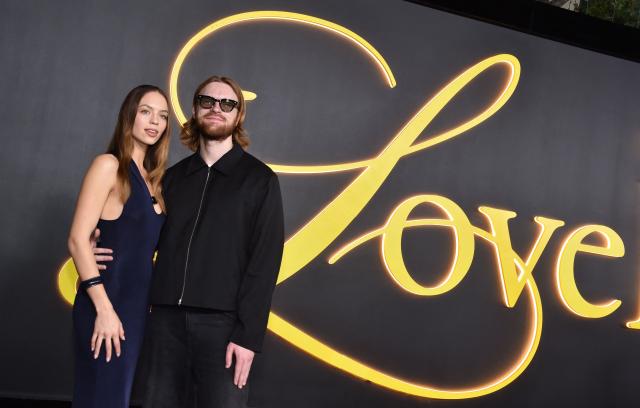 US record producer and songwriter Finneas (R) and partner US content creator, actress and entrepreneur Claudia Sulewski attend the premiere of HBO's "I Love LA" at the Paramount Theatre in Los Angeles, California on October 28, 2025. (Photo by Chris DELMAS / AFP)
