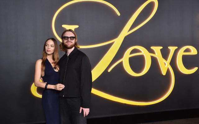 US record producer and songwriter Finneas (R) and partner US content creator, actress and entrepreneur Claudia Sulewski attend the premiere of HBO's "I Love LA" at the Paramount Theatre in Los Angeles, California on October 28, 2025. (Photo by Chris DELMAS / AFP)