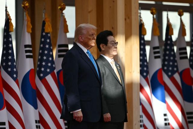South Korean President Lee Jae Myung and US President Donald Trump attend an arrival ceremony at the Gyeongju National Museum in Gyeongju on October 29, 2025. (Photo by ANDREW CABALLERO-REYNOLDS / AFP)