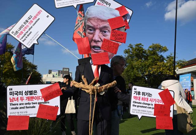 A South Korean protester wears a mask of Trump during a rally against US President Trump's visit to attend the Asia-Pacific Economic Cooperation (APEC) Summit, in Gyeongju on October 29, 2025. (Photo by Jung Yeon-je / AFP)