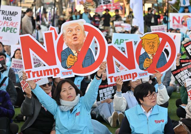 South Korean protesters hold placards reading "No Trump" during a rally against US President Donald Trump's visit to attend the Asia-Pacific Economic Cooperation (APEC) Summit, in Gyeongju on October 29, 2025. (Photo by Jung Yeon-je / AFP)