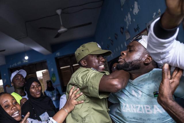A Tanzanian police officer intervenes to stop a man accused of attempting to taint the voting process at a polling station in Stone Town on October 29, 2025, during Tanzanias presidential elections. Polls opened on October 29, 2025 in Tanzania elections in which the main challengers were either jailed or barred from running, with rights groups decrying a "wave of terror".
President Samia Suluhu Hassan, 65, is determined to cement her position with an emphatic victory that will silence critics within her own party, analysts say. (Photo by MARCO LONGARI / AFP)