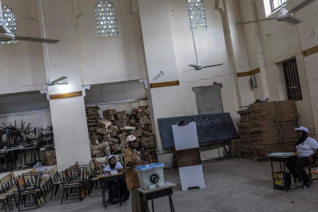 A man casts his ballot at a polling station in Stone Town on October 29, 2025, during Tanzania’s presidential elections. Polls opened on October 29, 2025 in Tanzania elections in which the main challengers were either jailed or barred from running, with rights groups decrying a "wave of terror".
President Samia Suluhu Hassan, 65, is determined to cement her position with an emphatic victory that will silence critics within her own party, analysts say. (Photo by MARCO LONGARI / AFP)