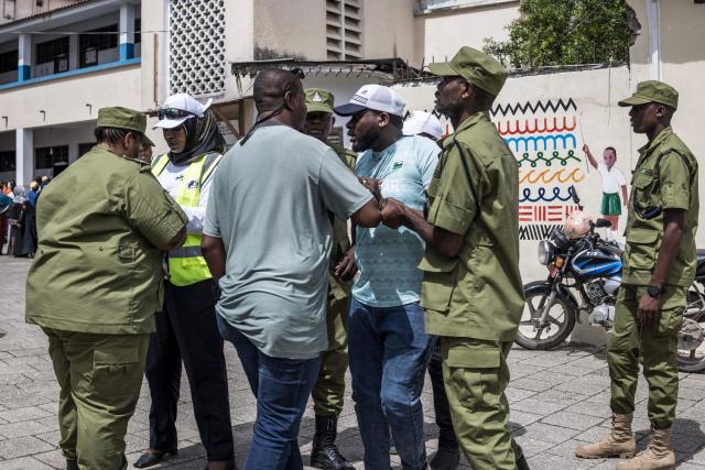 Tanzanian police officers detain a man (C) accused by electoral officials of attempting to taint the voting process at a polling station in Stone Town on October 29, 2025, during Tanzanias presidential elections. Polls opened on October 29, 2025 in Tanzania elections in which the main challengers were either jailed or barred from running, with rights groups decrying a "wave of terror".
President Samia Suluhu Hassan, 65, is determined to cement her position with an emphatic victory that will silence critics within her own party, analysts say. (Photo by MARCO LONGARI / AFP)