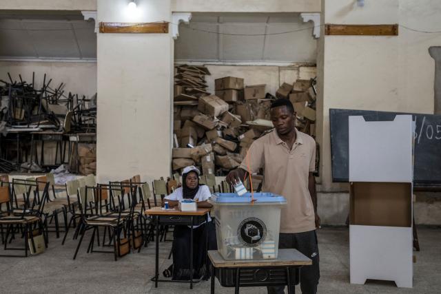 A man casts his ballot at a polling station in Stone Town on October 29, 2025, during Tanzania’s presidential elections. Polls opened on October 29, 2025 in Tanzania elections in which the main challengers were either jailed or barred from running, with rights groups decrying a "wave of terror".
President Samia Suluhu Hassan, 65, is determined to cement her position with an emphatic victory that will silence critics within her own party, analysts say. (Photo by MARCO LONGARI / AFP)