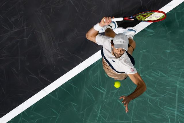 Monaco's Valentin Vacherot serves to France's Arthur Rinderknech during their men's singles match on day three of the Paris ATP Masters 1000 tennis tournament at the Paris La Défense Arena in Nanterre, on the outskirts of Paris, on October 29, 2025. (Photo by Dimitar DILKOFF / AFP)