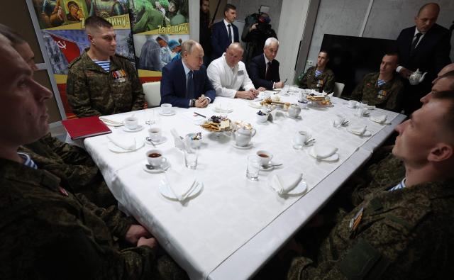 In this pool photograph distributed by the Russian state agency Sputnik, Russia's President Vladimir Putin (L-C) speaks as he visits servicemen who were wounded during the Russian military action in Ukraine, at a military hospital in Moscow on October 29, 2025. (Photo by Vyacheslav Prokofiev / POOL / AFP)