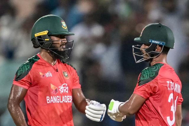 Bangladesh's Tanzid Hasan (R) celebrates with teammate Jaker Ali after scoring a half-century (50 runs) during the second Twenty20 international cricket match between Bangladesh and West Indies at the Bir Sreshtho Flight Lieutenant Matiur Rahman Stadium in Chittagong on October 29, 2025. (Photo by Munir UZ ZAMAN / AFP)