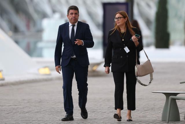 Valencia's regional president Carlos Mazon (L) arrives to attend a state memorial for the more than 230 victims of last year's floods on the one year anniversary of the disaster at the City of Arts and Sciences cultural and architectural complex in Valencia on October 29, 2025. The regional government has declared a day of mourning, while the town of Paiporta, at the epicentre of the disaster, will observe three days of remembrance. (Photo by Oscar DEL POZO / AFP)