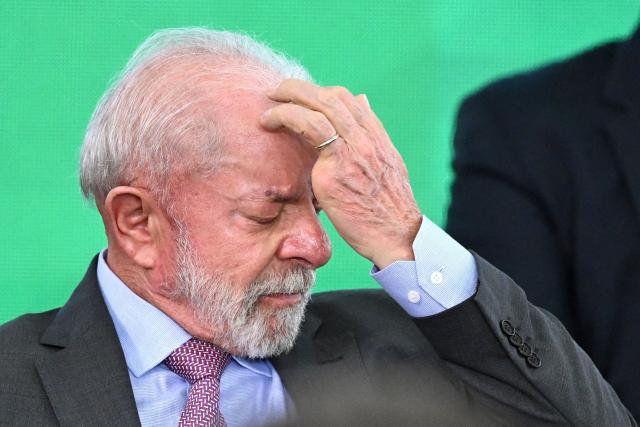 (FILES) Brazil's President Luiz Inacio Lula da Silva gestures during the launch of a home renovation program for low-income families at Planalto Palace in Brasilia on October 20, 2025. Brazilian President Luiz Inacio Lula da Silva is "horrified" by the death toll from a massive police raid on Rio drug gangs, which left scores dead, one of his ministers said on October 29, 2025. (Photo by Evaristo Sa / AFP)