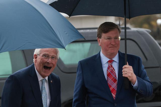 US Senator Roger Wicker (R-MS) reacts while standing with Mississippi Governor Tate Reeves (R), as they wait to meet US Vice President JD Vance and US second lady Usha Vance at Tupelo Regional Airport in Tupelo, Mississippi, October 29, 2025. (Photo by Jonathan Ernst / POOL / AFP)