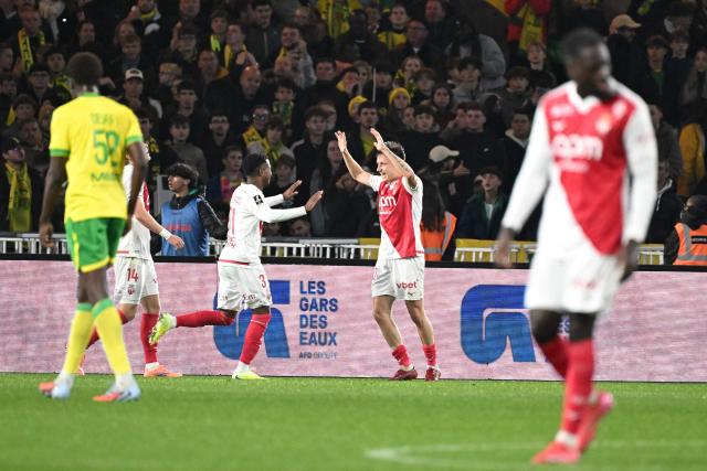 Monaco's Russian midfielder #10 Aleksandr Golovin (C) celebrates scoring a goal with Monaco's Spanish forward #31 Ansu Fati (L) during the French L1 football match between FC Nantes and AS Monaco at the Stade de la Beaujoire-Louis Fonteneau in Nantes, western France, on October 29, 2025. (Photo by Sebastien Salom-Gomis / AFP)