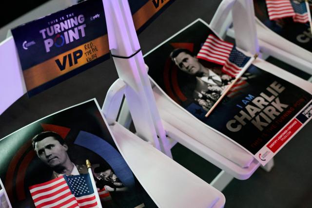 Signs with the image of late right-wing activist Charlie Kirk are pictured during a Turning Point USA where US Vice President JD Vance is expected, at the University of Mississippi, in Oxford, Mississippi, October 29, 2025. (Photo by JONATHAN ERNST / POOL / AFP)