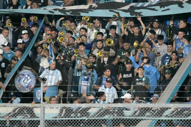 Fans of Racing cheer for their team ahead of the Copa Libertadores semifinal second leg football match between Argentina's Racing and Brazil's Flamengo at the Presidente Juan Domingo Peron - El Cilindro stadium in Avellaneda, Buenos Aires province, on October 29, 2025. (Photo by JUAN MABROMATA / AFP)