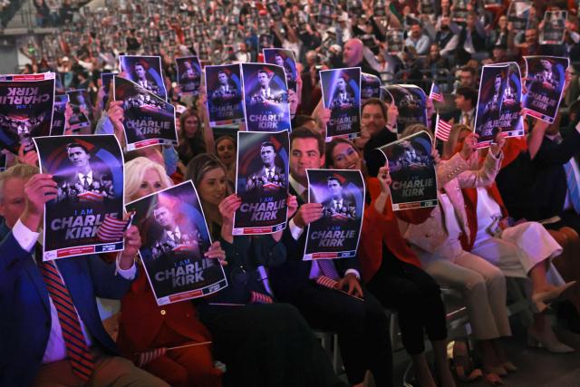 Attendees hold posters of late right-wing activist Charlie Kirk during a Turning Point USA event at the University of Mississippi, in Oxford, Mississippi, October 29, 2025. (Photo by JONATHAN ERNST / POOL / AFP)