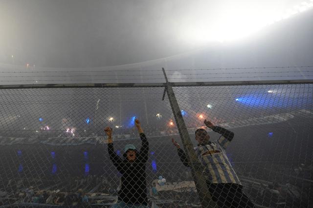 Fans of Racing cheer for their team ahead of the Copa Libertadores semifinal second leg football match between Argentina's Racing and Brazil's Flamengo at the Presidente Juan Domingo Peron - El Cilindro stadium in Avellaneda, Buenos Aires province, on October 29, 2025. (Photo by LUIS ROBAYO / AFP)