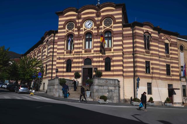 People walk past the county building in the city of Vranje, Southern Serbia, on October 20, 2025. Serbia is preparing to mark the first anniversary of the Novi Sad tragedy, which sparked some of the biggest protests in its history — a year that left the country deeply changed and polarised.
The train-station collapse in the country’s second-largest city, which killed 16 people just months after renovation, became a symbol of entrenched corruption — bringing hundreds of thousands to the streets under the "bloody hand" stencil that became its emblem. (Photo by Andrej ISAKOVIC / AFP)