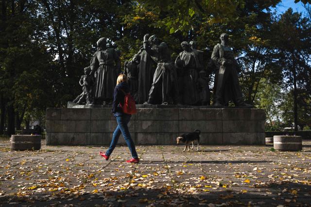 A woman walks past a WWII monument in the city of Kraljevo, Central Serbia, on October 21, 2025. Serbia is preparing to mark the first anniversary of the Novi Sad tragedy, which sparked some of the biggest protests in its history — a year that left the country deeply changed and polarised.
The train-station collapse in the country’s second-largest city, which killed 16 people just months after renovation, became a symbol of entrenched corruption — bringing hundreds of thousands to the streets under the "bloody hand" stencil that became its emblem, (Photo by Andrej ISAKOVIC / AFP)