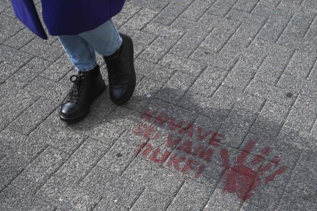 A student walks past a stencil reading, "You have blood on your hands!", in the city of Novi Pazar, South-western Serbia, on October 22, 2025. Serbia is preparing to mark the first anniversary of the Novi Sad tragedy, which sparked some of the biggest protests in its history — a year that left the country deeply changed and polarised.
The train-station collapse in the country’s second-largest city, which killed 16 people just months after renovation, became a symbol of entrenched corruption — bringing hundreds of thousands to the streets under the "bloody hand" stencil that became its emblem, (Photo by Andrej ISAKOVIC / AFP)