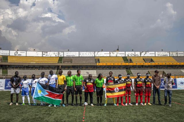 South Sudan and Uganda blind football teams pose with the referees before a match at Hamz Stadium Nakivubo War Memorial Grounds in Kampala, on October 27, 2025. South Sudan's national blind football team, the Bright Stars, is making its international debut in a mini-tournament in Kampala, featuring teams from Uganda and Zimbabwe. The tournament offers the team greater visibility and a chance to compete for a spot at the 2028 Paralympics in California. South Sudan's team began humbly five years ago with just two players under the guidance of sighted head coach Simon Madol Akol, who has since grown the team to 40 members. (Photo by Stuart Tibaweswa / AFP)