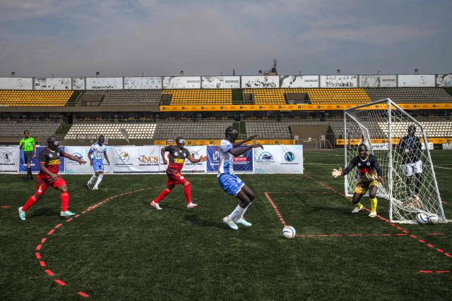 Players from South Sudans blind football team make their way to the pitch to play a match against Uganda at Hamz Stadium Nakivubo War Memorial Grounds in Kampala, on October 27, 2025. South Sudan's national blind football team, the Bright Stars, is making its international debut in a mini-tournament in Kampala, featuring teams from Uganda and Zimbabwe. The tournament offers the team greater visibility and a chance to compete for a spot at the 2028 Paralympics in California. South Sudan's team began humbly five years ago with just two players under the guidance of sighted head coach Simon Madol Akol, who has since grown the team to 40 members. (Photo by Stuart Tibaweswa / AFP)