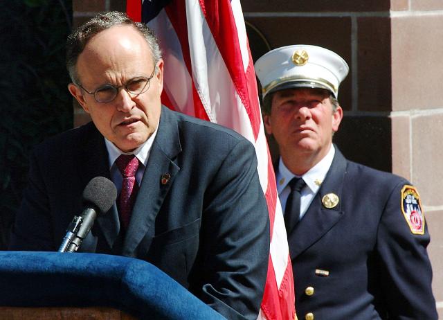 (FILES) New York City Mayor Rudolph Giuliani (l) speaks at a New York Fire Department promotions ceremony near NYFD headquarters in Brooklyn, New York 16 September, 2001. New York's mayors are an eclectic bunch: from uniters to heroes-turned-villains and those accused of corruption. Here is what to know about five of the most high-profile mayors of The Big Apple as the city prepares to pick its 111th leader on November 4 (Photo by HENNY RAY ABRAMS / AFP)