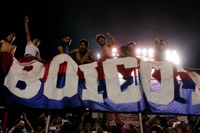 Fans of Xelaju celebrate after their team won the penalty shootout and the second leg of the CONCACAF Central American Cup semifinal football match between Guatemala's Xelaju and Honduras's Real Espana at Cementos Progreso Stadium in Guatemala City on October 29, 2025. (Photo by Edwin BERCIAN / AFP)