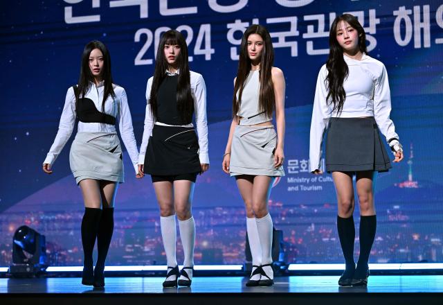 (FILES) K-pop girl group 'NewJeans' members Hanni, Haerin, Danielle and Minji attend an appointment ceremony of the 2024 Korea Tourism Honorary Ambassador at a hotel in Seoul on July 11, 2024. A South Korean court ruled on October 30, 2025 against popular K-pop group NewJeans, whose members had sought to cut contractual ties with their label ADOR over what they called "mistreatment" by the agency. (Photo by Jung Yeon-je / AFP)