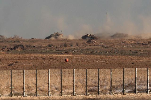 TOPSHOT - Israeli tanks move along a path in the Gaza Strip as seen from a position in the south, near the Israel–Gaza border fence, on October 30, 2025. Israel said it struck an arms dump in Gaza on October 29, hours after the deadliest night of bombing since the start of a US-brokered truce, warning it would continue to operate to take out perceived threats. (Photo by Jack GUEZ / AFP)