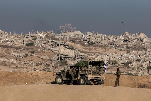 TOPSHOT - Israeli soldier take up a position near the Israel–Gaza border fence on October 30, 2025. Israel said it struck an arms dump in Gaza on October 29, hours after the deadliest night of bombing since the start of a US-brokered truce, warning it would continue to operate to take out perceived threats. (Photo by Jack GUEZ / AFP)