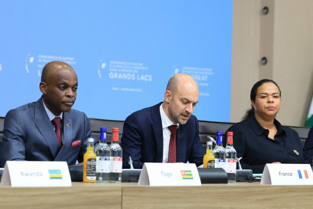 France's Foreign Affairs Minister Jean-Noel Barrot (C) speaks next Togo's Foreign Minister Robert Dussey (L) and Democratic Republic of the Congo Foreign Minister Therese Kayikwamba during a conference in support of peace and prosperity in the Great Lakes region, in Paris, on October 30, 2025. The international community gathered in Paris on October 30, 2025 to raise awareness about the dire humanitarian situation in the Great Lakes region, aiming to raise hundreds of millions of euros despite a drastic decrease in international aid, particularly from the United States. (Photo by Alain JOCARD / POOL / AFP)