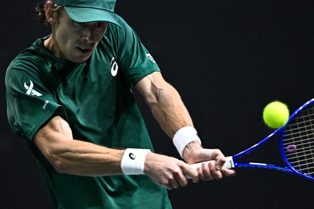 Australia's Alex De Minaur plays a backhand return to Russia's Karen Khachanov during their men's singles match on day four of the Paris ATP Masters 1000 tennis tournament at the Paris La Défense Arena in Nanterre, on the outskirts of Paris, on October 30, 2025. (Photo by JULIEN DE ROSA / AFP)