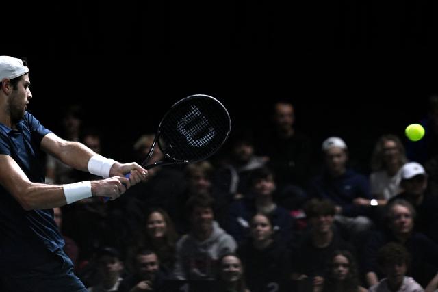 Russia's Karen Khachanov plays a backhand return to Australia's Alex De Minaur during their men's singles match on day four of the Paris ATP Masters 1000 tennis tournament at the Paris La Défense Arena in Nanterre, on the outskirts of Paris, on October 30, 2025. (Photo by JULIEN DE ROSA / AFP)