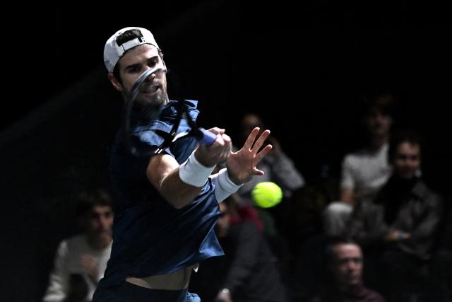 Russia's Karen Khachanov plays a forehand return to Australia's Alex De Minaur during their men's singles match on day four of the Paris ATP Masters 1000 tennis tournament at the Paris La Défense Arena in Nanterre, on the outskirts of Paris, on October 30, 2025. (Photo by JULIEN DE ROSA / AFP)