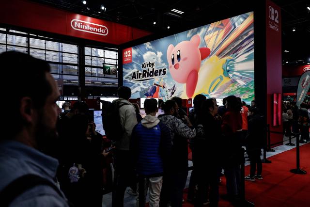 Visitors interact at the Nintendo area during the Paris Games Week fair in Paris, on October 30, 2025. Supported by new partners, the 14th edition of the largest video game fair in France is making its return until November 2, 2025 at the Porte de Versailles in Paris, in a format even more focused on shows and pop culture. (Photo by STEPHANE DE SAKUTIN / AFP)