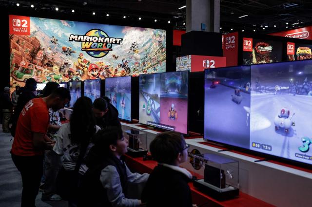 Visitors play Mario Kart at the Nintendo area during the Paris Games Week fair in Paris, on October 30, 2025. Supported by new partners, the 14th edition of the largest video game fair in France is making its return until November 2, 2025 at the Porte de Versailles in Paris, in a format even more focused on shows and pop culture. (Photo by STEPHANE DE SAKUTIN / AFP)