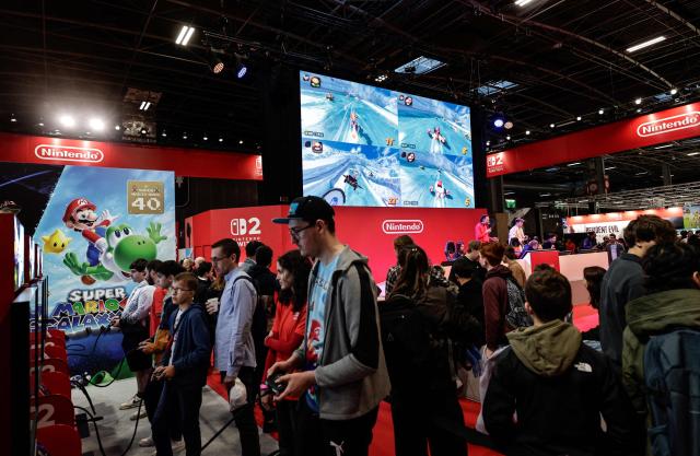Visitors play Mario Kart at the Nintendo area during the Paris Games Week fair in Paris, on October 30, 2025. Supported by new partners, the 14th edition of the largest video game fair in France is making its return until November 2, 2025 at the Porte de Versailles in Paris, in a format even more focused on shows and pop culture. (Photo by STEPHANE DE SAKUTIN / AFP)