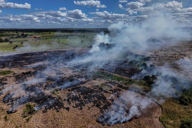(FILES) Aerial view of a field fire, in Sao Felix do Xingu, Para state, Brazil, taken on June 16, 2025. Annual deforestation in Brazil's portion of the Amazon rainforest dropped 11 percent year-on-year, the government said on October 30, 2025, just days before the country hosts UN climate talks. (Photo by Ivan PISARENKO / AFP)