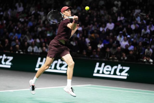 Italy's Jannik Sinner plays a forehand return to Argentine's Francisco Cerundolo during their men's singles match on day four of the Paris ATP Masters 1000 tennis tournament at the Paris La Défense Arena in Nanterre, on the outskirts of Paris, on October 30, 2025. (Photo by Dimitar DILKOFF / AFP)
