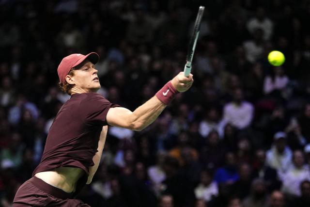 Italy's Jannik Sinner plays a forehand return to Argentine's Francisco Cerundolo during their men's singles match on day four of the Paris ATP Masters 1000 tennis tournament at the Paris La Défense Arena in Nanterre, on the outskirts of Paris, on October 30, 2025. (Photo by Dimitar DILKOFF / AFP)