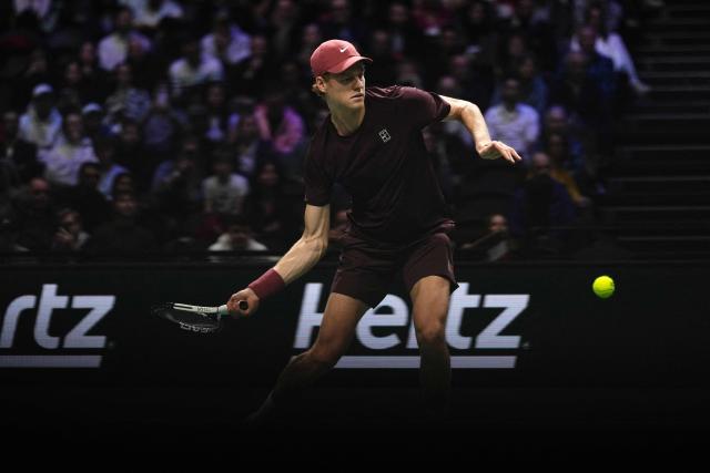 Italy's Jannik Sinner plays a forehand return to Argentine's Francisco Cerundolo during their men's singles match on day four of the Paris ATP Masters 1000 tennis tournament at the Paris La Défense Arena in Nanterre, on the outskirts of Paris, on October 30, 2025. (Photo by Dimitar DILKOFF / AFP)