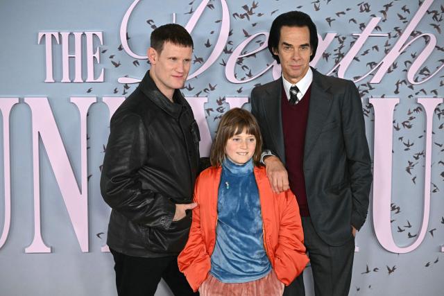 (L-R) British actor Matt Smith. British actor Rafael Mathe and Australian musician and author Nick Cave pose on the red carpet upon arrival to attend the world premiere of TV series 'The Death of Bunny Munro', based on a novel by Nick Cave of the same name, at the Royal Festival Hall in London on October 30, 2025. (Photo by JUSTIN TALLIS / AFP)