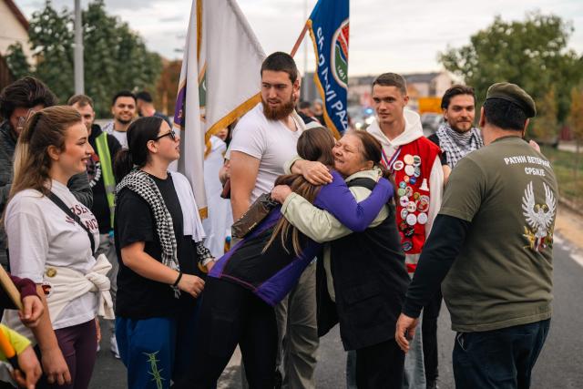 Students are welcomed by local residents as they march trough the town of Stara Pazova towards the city of Novi Sad to attend a mass commemoration marking the first anniversary of the railway tragedy, in Stara Pazova, on October 30, 2025, Nearly one year ago, on November 1, 2024, a railway station canopy collapsed in Serbia's second city of Novi Sad, killing 16 people and triggering huge demonstrations. (Photo by Uros Arsic / AFP)