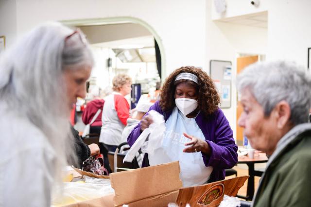 Volunteers at the Lutheran Settlement House pack bags of groceries to distribute to the local community for their daily food pantry in Philadelphia, Pennsylvania, on October 30, 2025. Starting on November 1, Supplemental Nutrition Assistance Program or SNAP benefits are set to lapse impacting millions of Americans amid the government shutdown. Local food pantries such as the Lutheran Settlement House in Philadelphia are experiencing an increase in visits. (Photo by Matthew HATCHER / AFP)